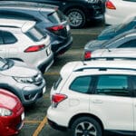 Car parked at parking lot of the airport for rental. Aerial view of car parking lot of the airport. Used luxury car for sale and rental service. Automobile parking space. Car dealership concept.